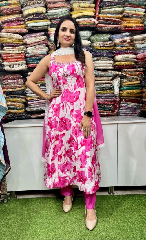A vibrant designer digital print Anarkali set featuring intricate patterns, featuring a long flowing kurta with detailed motifs, paired with matching churidar and a stylish dupatta, perfect for festive and special occasions.
