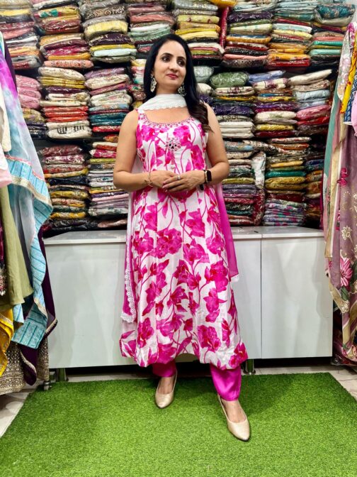 A vibrant designer digital print Anarkali set featuring intricate patterns, featuring a long flowing kurta with detailed motifs, paired with matching churidar and a stylish dupatta, perfect for festive and special occasions.